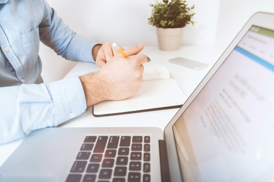 Writing a business update at a laptop